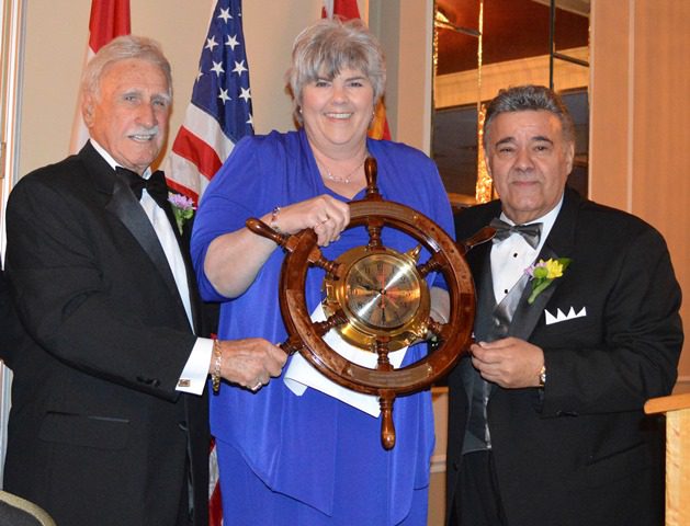 During the 2013 St. Louis PMC Dinner, State Senator Gina Walsh receives the Able Helmsmen Award from PMC Pres Richard Mantia (left) and MTD Pres Michael Sacco.