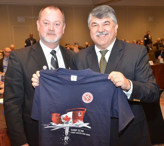 MTD Eastern Area Exec Bd Mbr Jim Given (left) presents AFL-CIO Pres Richard Trumka with a Canadian Maritime and Supply Chain Coalition t-shirt. 