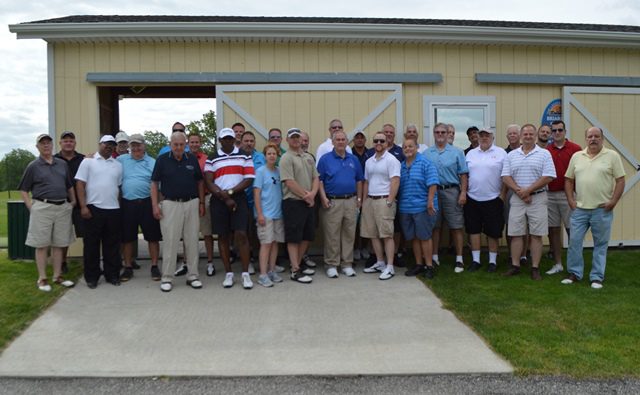 Before hitting the links, golfers in the Cleveland PMC Golf Outing gather for instructions.