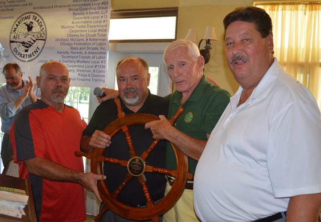 Bob Howard (second from left) receives the Chicago and Western Lakes PMC 'Unionist of the Year' ship's wheel from (L-R) PLC Secretary-Treasurer Chad Partridge, Past President Tom Faul and PMC President James Sanfilippo.