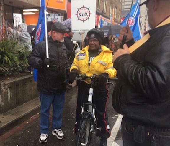 MTD Eastern Area Executive Board Member Jim Given speaks with a local police officer during the Toronto march.