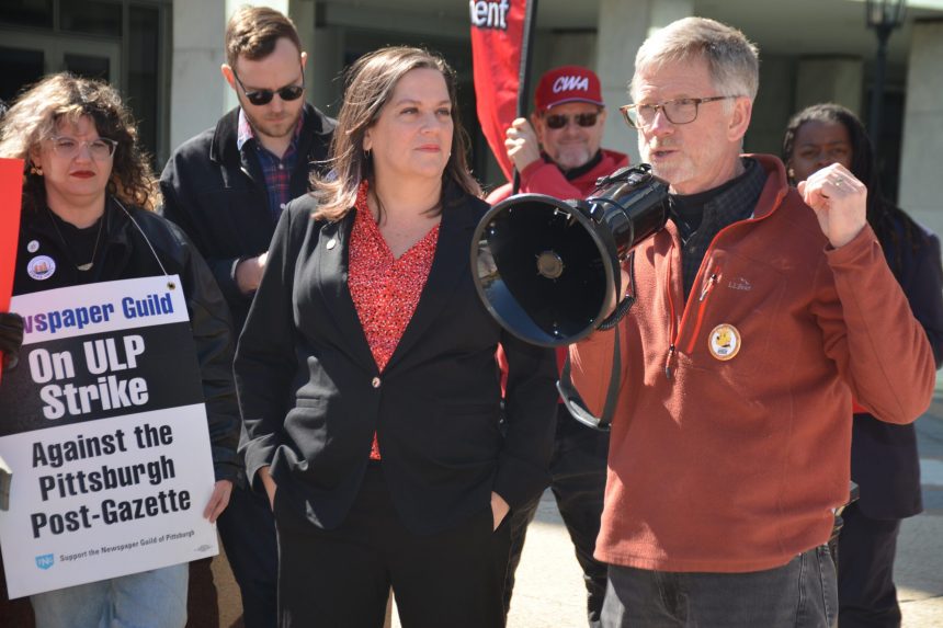 Post-Gazette multimedia journalist Steve Mellon (right) addresses the crowd while Copy Editor Erin Hebert (left) and CWA Sec-Treas. Sara Steffens look on. In the background are NewsGuild-CWA Pres. Jon Schleuss (left) and AFA-CWA IVP Keturah Johnson.
